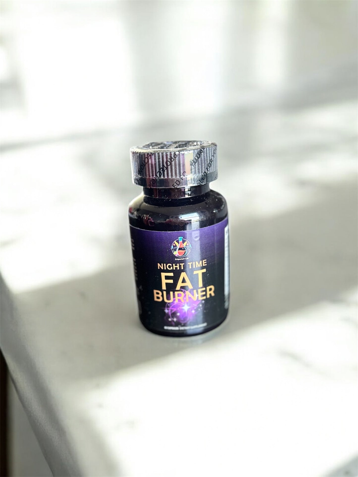 Fat burner supplement bottle on a light surface with soft shadows