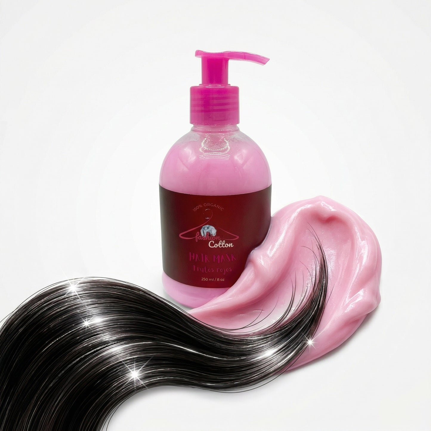 Pink hair care product with a pump dispenser next to wavy black hair strands on a white background