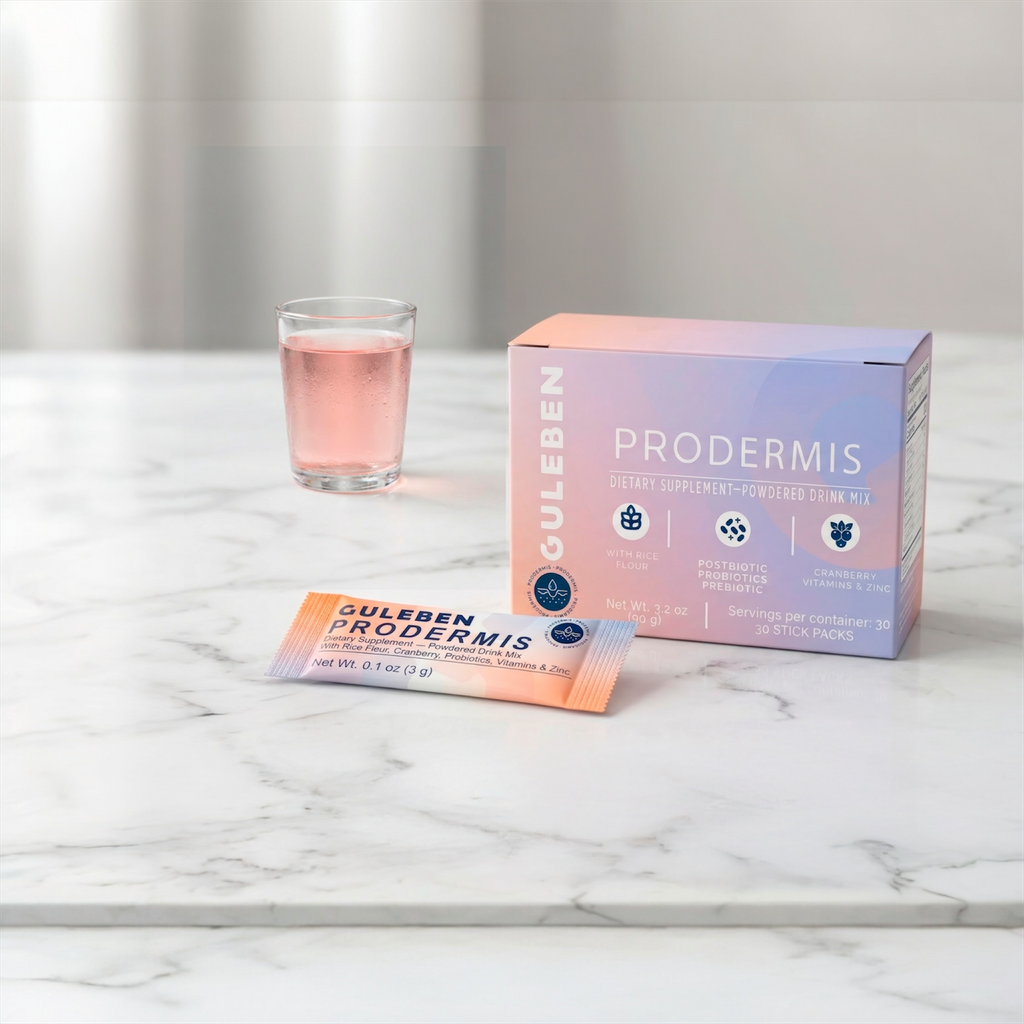 Guleben Prodermis packaging on a marble surface with a glass of pink liquid.