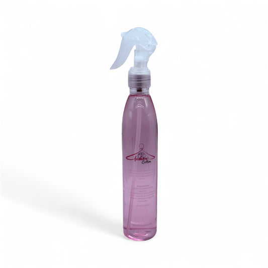 Pink spray bottle with a white nozzle on a white background